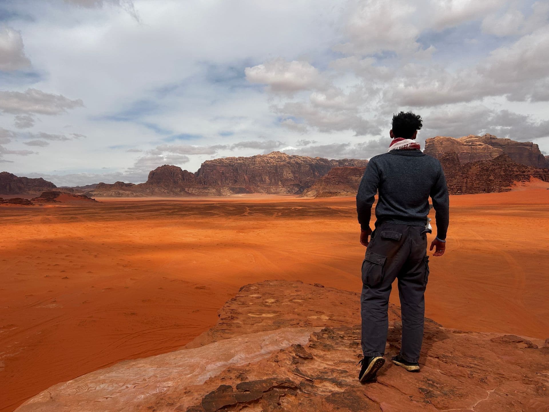 Person overlooking Wadi Rum desert landscape in Jordan