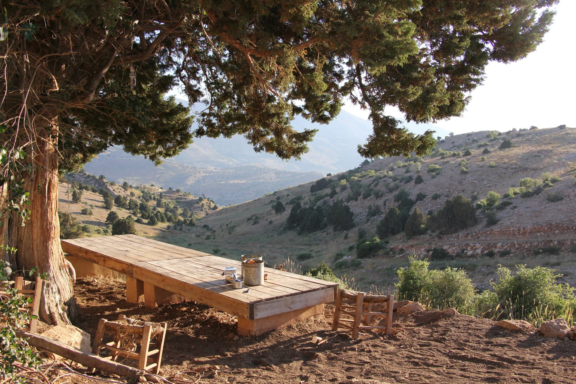 A small table set against the mountains — the meal, the conversation, the part the tools can’t replace